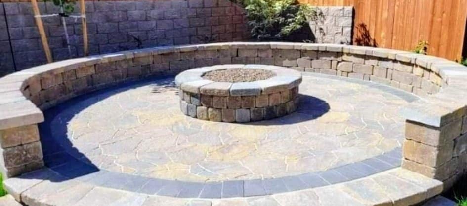 Circular stone fire pit with seating wall