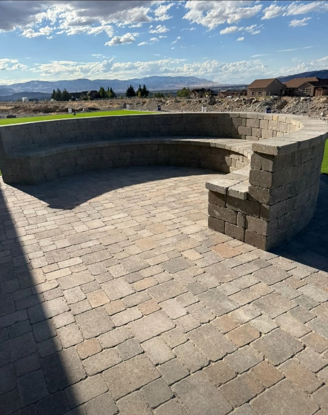 Custom paver patio with seating wall and mountain view