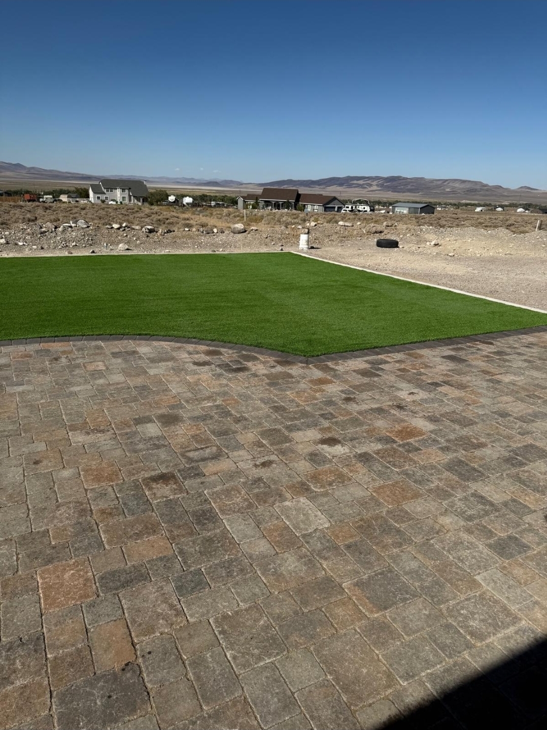 Tan cobblestone paver patio with mountain view